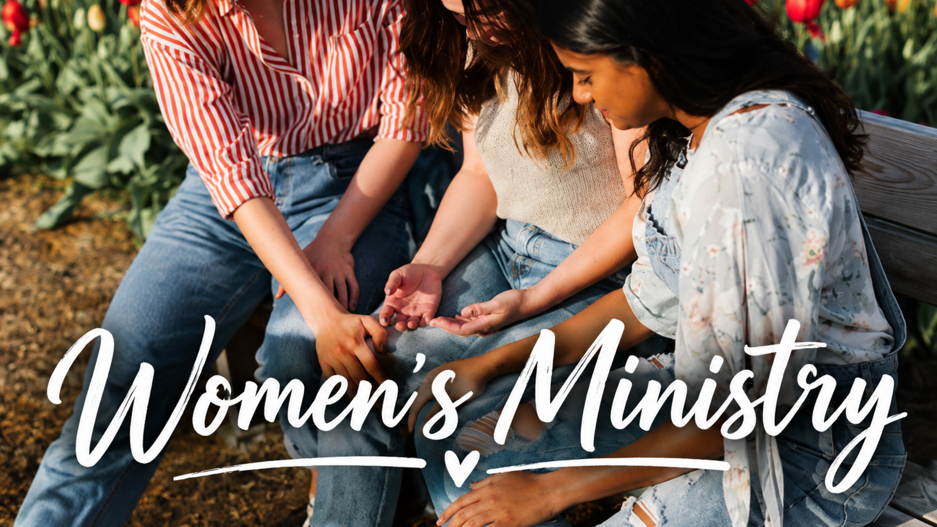 A few women holding hands in prayer.